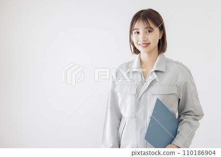 一個穿著工作服的女人拿著剪貼板 110186904