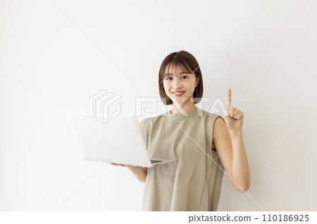 A young woman using a laptop 110186925