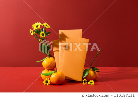 Red background featured some envelopes in yellow color and tangerines. Flowers decorated. The Chinese lunar calendar is used to determine the Chinese New Year Red background featured some envelopes in yellow color and tangerines. Flowers decorated. The Chinese lunar calendar is used to determine the Chinese New Year 110187131