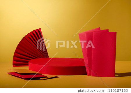 Empty red podium decorated with red paper fan and several envelopes in yellow and red color. Mock-up for exhibitions or presentation of cosmetic products or packaging Empty red podium decorated with red paper fan and several envelopes in yellow and red color. Mock-up for exhibitions or presentation of cosmetic products or packaging 110187163