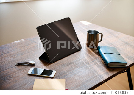 Tablet terminal and business goods placed on the desk Tablet terminal and business goods placed on the desk 110188351