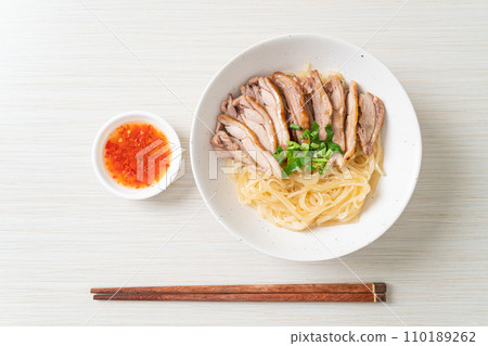 dried noodles with stewed duck in white bowl 110189262