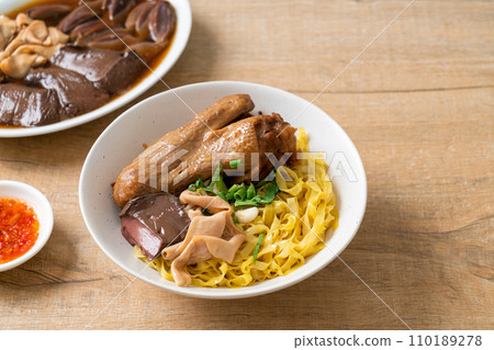 Egg noodles served dry with braised duck 110189278