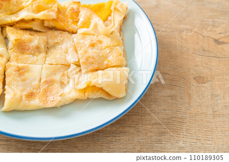 roti with egg and sweetened condensed milk 110189305