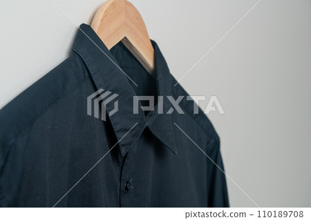 hanging shirt with wood hanger on wall hanging shirt with wood hanger on wall 110189708
