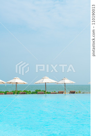 umbrella with bed pool around swimming pool with ocean sea background 110190013