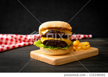 hamburger or beef burgers with cheese and french fries 110190092