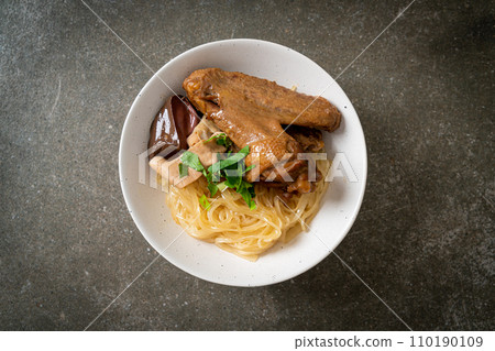 dried noodles with braised duck in white bowl 110190109