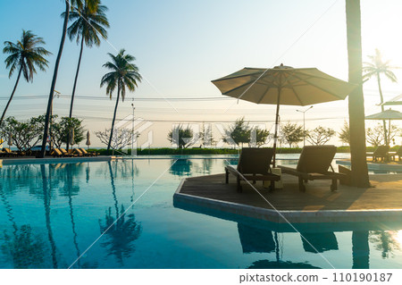 umbrella with bed pool around swimming pool with ocean sea background umbrella with bed pool around swimming pool with ocean sea background 110190187