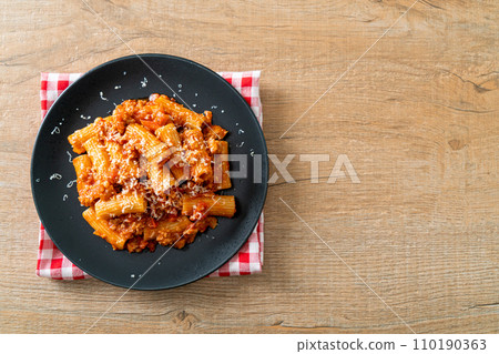 Rigatoni pasta bolognese with cheese 110190363