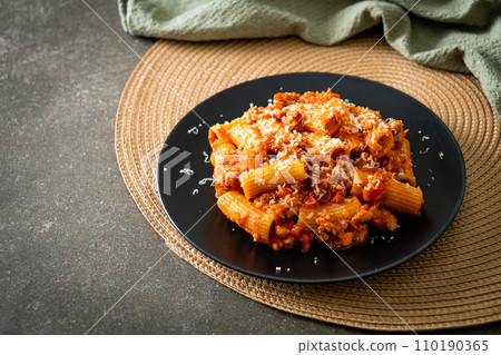 Rigatoni pasta bolognese with cheese Rigatoni pasta bolognese with cheese 110190365