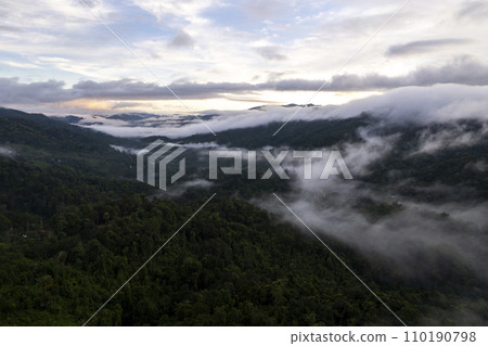 Top view Landscape of Morning Mist with Mountain Layer at north of Thailand. mountain ridge and clouds in rural jungle bush forest Top view Landscape of Morning Mist with Mountain Layer at north of Thailand. mountain ridge and clouds in rural jungle bush forest 110190798