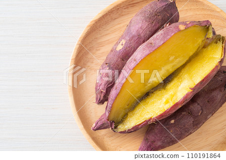 Grilled or baked Japanese sweet potatoes on wood plate Grilled or baked Japanese sweet potatoes on wood plate 110191864