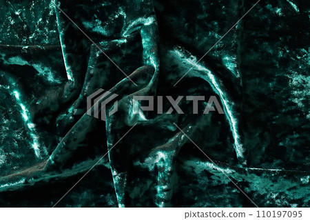 Snowflake shaped confetti on green velvet. Christmas background. Snowflake shaped confetti on green velvet. Christmas background. 110197095