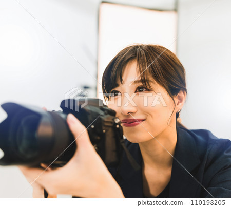 A female professional photographer is taking pictures A female professional photographer is taking pictures 110198205