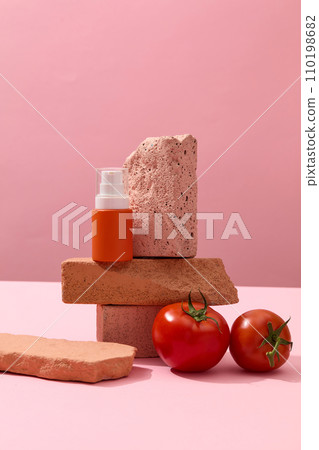 A stack of several stones with a pump bottle placed on, displayed with tomatoes. Mockup of skin care cosmetic bottle of beauty facial extracted from Tomato A stack of several stones with a pump bottle placed on, displayed with tomatoes. Mockup of skin care cosmetic bottle of beauty facial extracted from Tomato 110198682