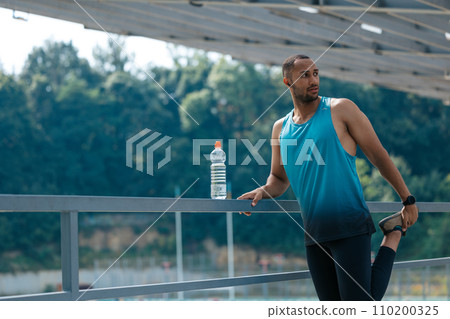 Handsome man in sportswear feeling good and looking confident 110200325
