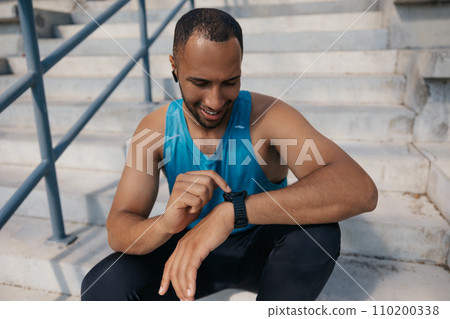 Young man in sportswear on the stairs after a good workout Young man in sportswear on the stairs after a good workout 110200338