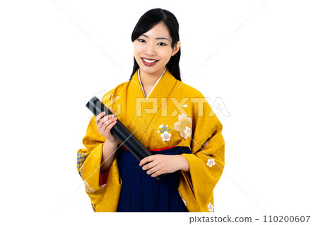 A woman in a hakama holding a diploma A woman in a hakama holding a diploma 110200607