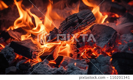 Burning firewood and coals of a fire close up 110201341