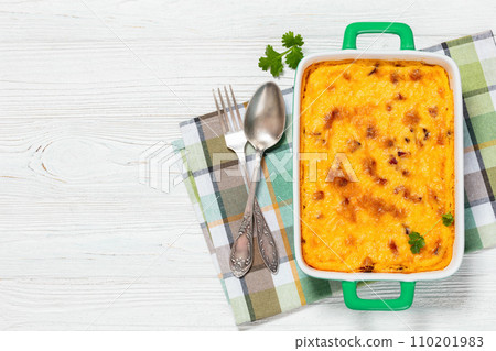 cheesy smoked sausage grits bake in ceramic dish 110201983