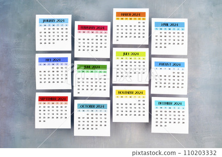 Months 1 to 12 January-December 2024 calendar page on blue wooden. 110203332