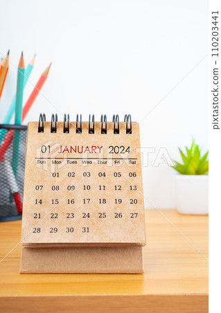 January 2024 Desk Calendar with wooden pencil on the table. 110203441