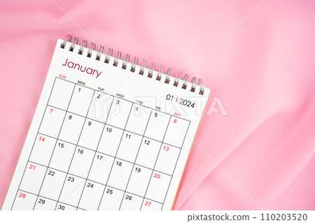 January 2024 month calendar on pink fabric background. 110203520
