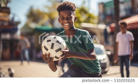 African American boy playing football in the local African American boy playing football in the local 110203820
