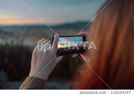 Woman take a photo of golden sunset over Palazzo Vecchio and Cathedral of Santa Maria del Fiore (Duomo), Florence, Italy Woman take a photo of golden sunset over Palazzo Vecchio and Cathedral of Santa Maria del Fiore (Duomo), Florence, Italy 110204247