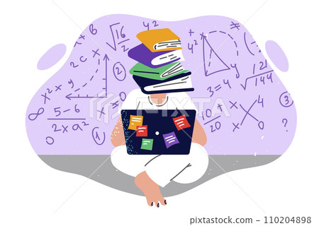 Student receives online education, sitting on floor with laptop on lap and books instead of head 110204898