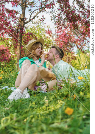 close-up portrait young couple, enjoying picnic in park 110205216