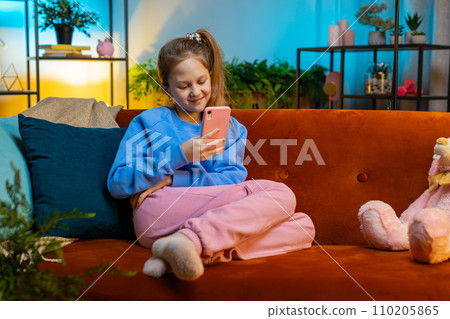 Young child kid girl texting share messages content on smartphone social media applications online 110205865