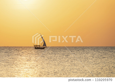 Typical african boat sails in the ocean at sunset 110205970