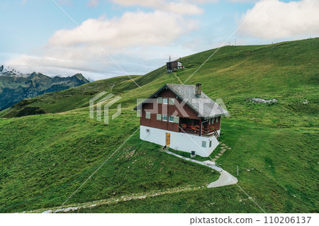 Wooden chalet on summit among the Schwyzer Alps in summer Wooden chalet on summit among the Schwyzer Alps in summer 110206137