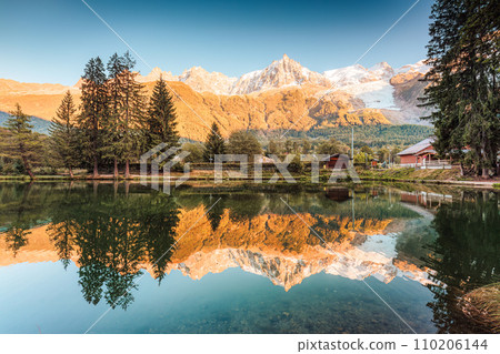 Lac des Gaillands with Mont Blanc massif and train at station in the sunset at Chamonix, France 110206144