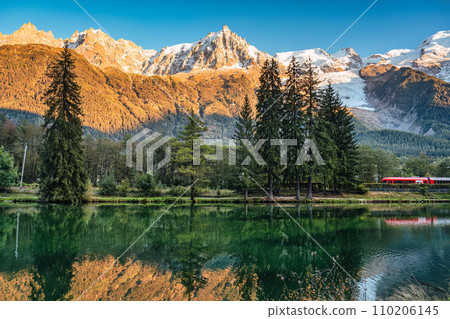Lac des Gaillands with train passing and Mont Blanc massif reflection in the sunset at Chamonix, France 110206145