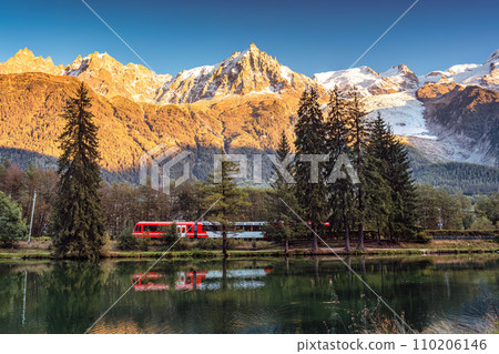 Lac des Gaillands with train passing and Mont Blanc massif reflection in the sunset at Chamonix, France Lac des Gaillands with train passing and Mont Blanc massif reflection in the sunset at Chamonix, France 110206146