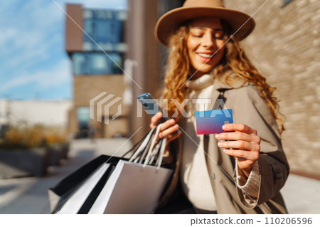 Hands of beautiful woman with telephone, credit card. Online shopping concept, lifestyle concept. 110206596