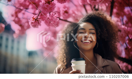 Modern happy young smiling dark-skinned African woman with a glass of coffee against the backdrop Modern happy young smiling dark-skinned African woman with a glass of coffee against the backdrop 110207006