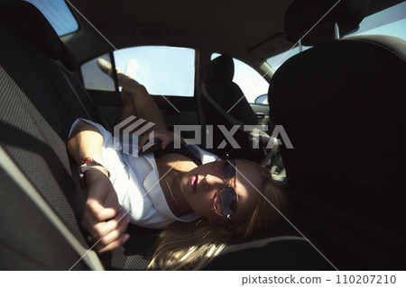 A beautiful girl poses in the back seat of a car, went to the village of work and bustle, serenity and freedom. Escape from problems and a chance to be alone skinny. High quality photo A beautiful girl poses in the back seat of a car, went to the village of work and bustle, serenity and freedom. Escape from problems and a chance to be alone skinny. High quality photo 110207210
