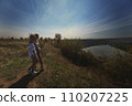 two best friends take a break from work, feel free and enjoy privacy. Blonde sisters in nature look at the landscape. Summer and good weather. High quality photo 110207225