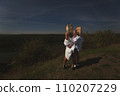 two best friends take a break from work, feel free and enjoy privacy. Blonde sisters in nature look at the landscape. Summer and good weather. High quality photo 110207229