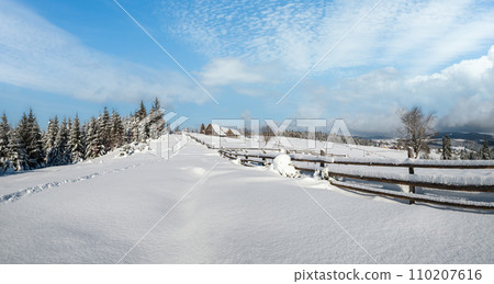 Countryside hills, groves and farmlands in winter remote alpine mountain village Countryside hills, groves and farmlands in winter remote alpine mountain village 110207616