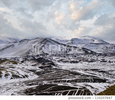 Season changing in southern Highlands of Iceland. Colorful Landmannalaugar mountains under snow cover in autumn. Season changing in southern Highlands of Iceland. Colorful Landmannalaugar mountains under snow cover in autumn. 110207687