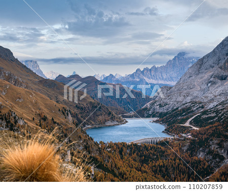 Autumn Dolomites mountain view from hiking path betwen Pordoi Pass and Fedaia Lake, Italy. Autumn Dolomites mountain view from hiking path betwen Pordoi Pass and Fedaia Lake, Italy. 110207859
