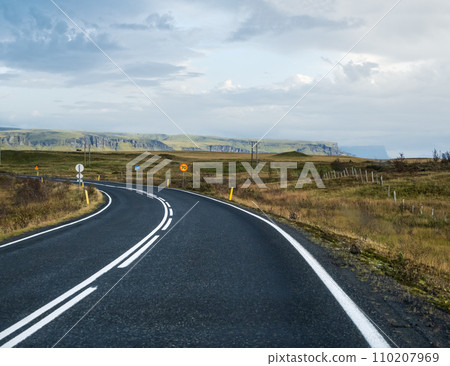 Highway road and mountain view during auto trip in Iceland. Spectacular Icelandic landscape with  scenic nature 110207969