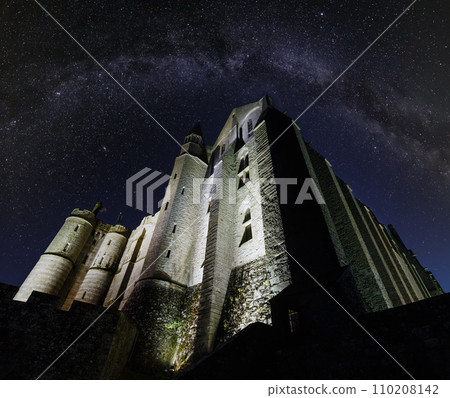 Mont Saint-Michel night view. Built in the XI-XVI centuries. The main facade of the church built in the 12th century. Architect William de Volpiano. Starry sky with Milkyway above. Mont Saint-Michel night view. Built in the XI-XVI centuries. The main facade of the church built in the 12th century. Architect William de Volpiano. Starry sky with Milkyway above. 110208142