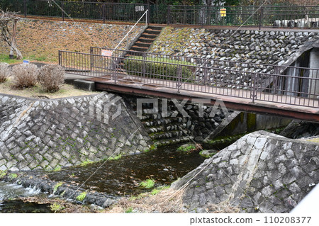 Clear stream flowing between rocks Clear stream flowing between rocks 110208377