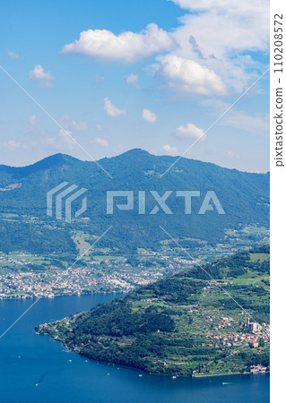 Mountain landscape, picturesque mountain lake in the summer morning, large panorama. Iseo, Italy Mountain landscape, picturesque mountain lake in the summer morning, large panorama. Iseo, Italy 110208572